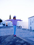 Girl Balancing on Edge, Caceres, Extremadura, Spain Photographic Print by Philip & Karen Smith