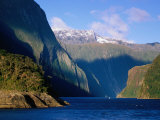 Boat in Distance Between Mountains, Milford Sound, New Zealand Photographic Print by Peter Hendrie