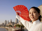 A Young Woman in a White Dress Does a Fan Dance with a Red Fan Photographic Print by Eightfish 