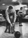 Dad Showing 3 Year Old Daughter the Basics of Bowling Photographic Print by George Silk