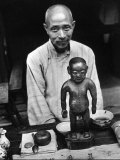 Old Style Chinese Doctor Setting Up His Office on Street During Market Day Photographic Print by Carl Mydans