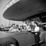 Women and Girls, in Convertible at Drive In, Greet Female Car Hop, Who Just Brought Their Drinks Photographic Print by Nina Leen