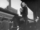 Actress Patricia Neal Sitting on Her Luggage on the Platform of a Train Station During a Stopover Premium Photographic Print by Ed Clark