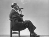 Architect Frederick Kiesler Seated in a Child's Chair, Smoking a Cigar, at Gjon Mili's Studio, Photographic Print