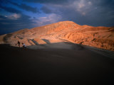 Couple of Hikers Walking Through Shadows at Dusk, Valle De La Luna, Chile Photographic Print by Aaron McCoy