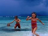 Children Running Out of Ocean in Stormy Weather, Seychelles Photographic Print by Philip & Karen Smith