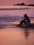 Woman Sitting on Beach at Sunset in Ixtapa, Near Zihuatanejo, Zihuatanejo, Mexico Photographic Print by Philip Smith