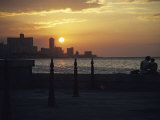 A Couple Embraces on Havanas Malecon Photographic Print by David Evans