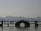 People Crossing a Bridge Over a Lake in Twilight, China Photographic Print by Ryan Ross