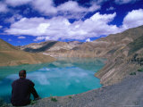 Traveller Sitting Overlooking the Turquoise Yamdrok Tso (Lake) on the Friendship Highway, China Photographic Print by Anthony Plummer