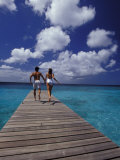 Couple Running on Dock, Curacao, Caribbean Photographic Print by Greg Johnston