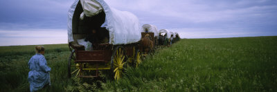 Historical Reenactment of a Woman Running Behind a Covered Wagon, North Dakota, USA Photographic Print