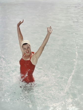 Happy Retro Girl Splashing Water with Arms Raised