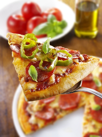 Slice of Pepperoni Pizza with Chilli Rings on Server Photographic Print