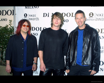 Goo Goo Dolls posing at awards show in photo poster