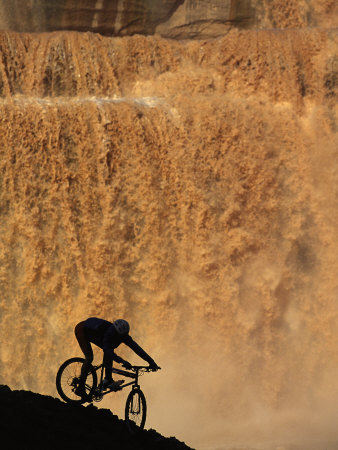 Mountain Biker Pedals Past Rushing Winter Snow Melt at Grand Falls Photographic Print by Bill Hatcher