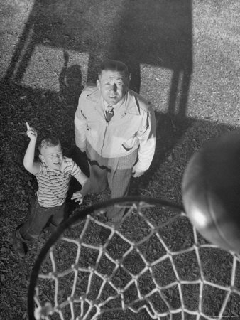 Oklahoma A&M Basketball Coach Hank Iba Watching a Young Boy Shooting a Basket Photographic Print by Myron Davis