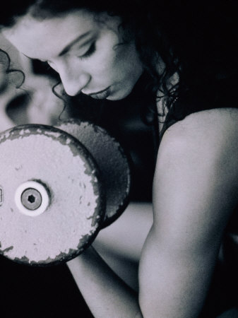 Young Woman Exercising with Dumbbells Photographic Print