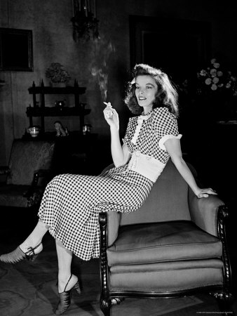 Katharine Hepburn in chair Smoking Cigarette in Scene from Broadway Show 