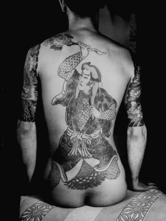 Man's Back Tattooed of a Man Dancing with a Chrysanthemum Design Known as