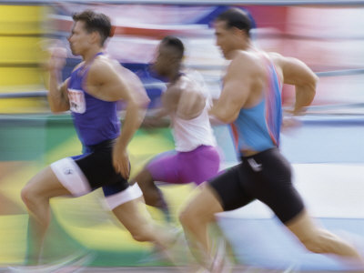 Side Profile of Three Men Running on a Running Track Photographic Print