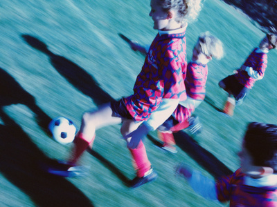 playing soccer. Children Playing Soccer