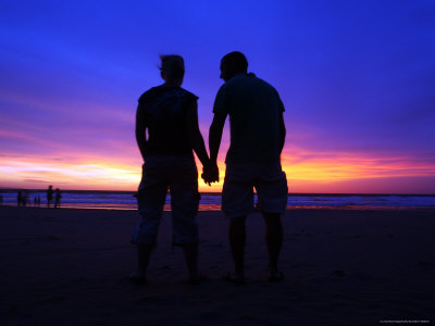 Silhouette of a Couple Holding Hands at Sunset Photographic Print