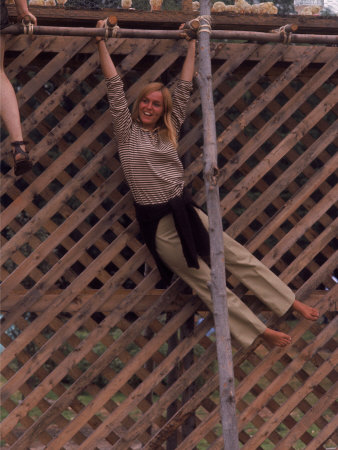 Barefoot Girl Swinging on Structure Containing Baby Chicks in Coop Barefoot Girl Swinging on Structure Containing Baby Chicks in Coop