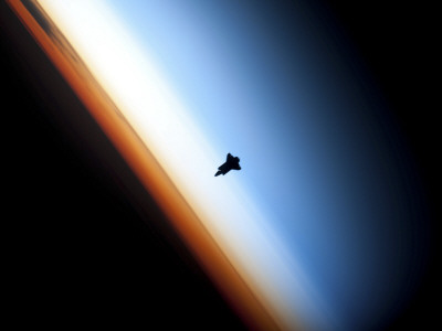 Silhouette of Space Shuttle Endeavour over Earth's Colorful Horizon Photographic Print