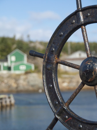 Fisherman's Point, Boat Wheel in Front of Harbor, Twillingate, Newfoundland and Labrador, Canada Photographic Print by Cindy Miller Hopkins