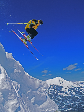 A Skier Jumps a Cornice at Exclusive Yellowstone Club Ski Area, Montana Photographic Print by Gordon Wiltsie