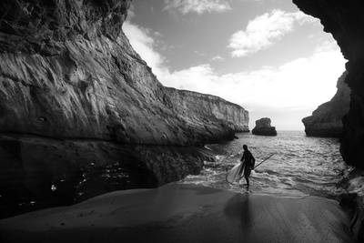 A Stand Up Paddleboarder on the Rough Coastline North of Santa Cruz Photographic Print by Ben Horton