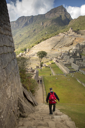 Man Walking Down Stone Steps of Machu Picchu, Peru Photographic Print by John & Lisa Merrill