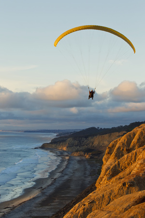 California, La Jolla, Paraglider Flying over Ocean Cliffs at Sunset. Editorial Use Only Photographic Print by  Design Pics Inc