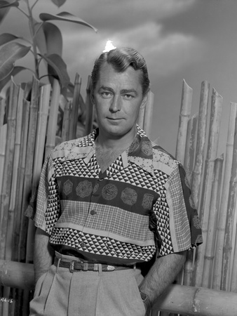Alan Ladd standing in Front of a Wooden Fence in Portrait in Classic Photo by  Movie Star News