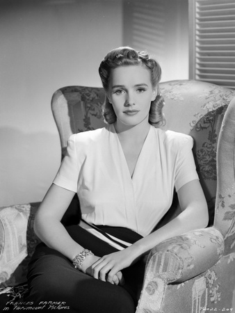 Frances Farmer on a V-Neck Top sitting on a Sofa Portrait Photo by  Movie Star News