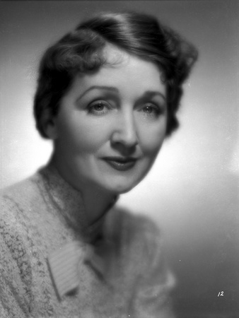 Hedda Hopper smiling in a Printed Turtle Neck Blouse Photo by  Movie Star News