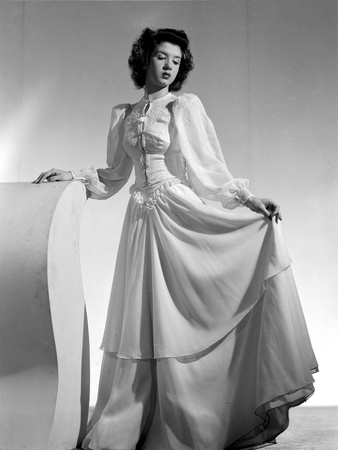 Peggy Ryan standing wearing White Elegant Gown Portrait Photo by  Movie Star News