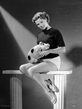 Nancy Gates sitting with a Piggy Bank Portrait Photo by  Movie Star News