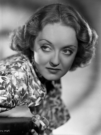 Bette Davis Portrait in Looking at the Right in Floral Silk Shirt with Curly Waved Hairstyle Photo by Elmer Fryer