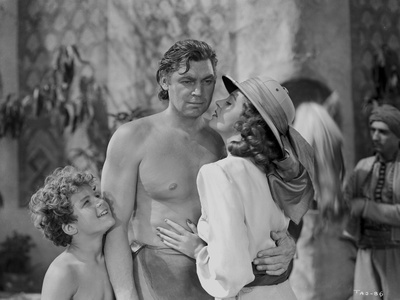 Johnny Weissmuller Receiving a Kiss from a City Girl in a Classic Movie Scene Photo by  Movie Star News