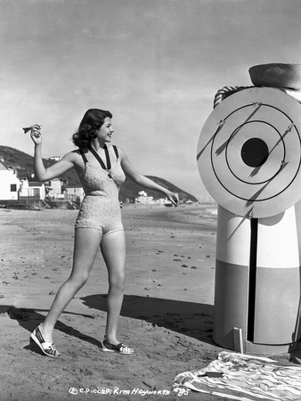 Rita Hayworth wearing a Swimming Suit Playing Dart Game Photo by  Movie Star News