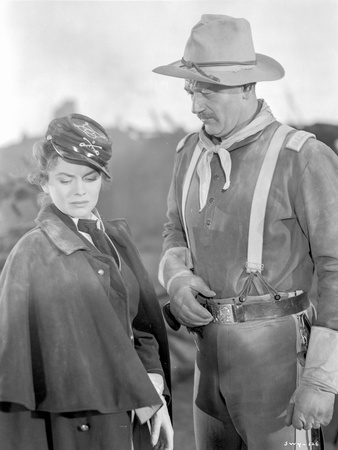 She Wore A Yellow Ribbon Man with Hat and Woman Talking Photo by  Movie Star News