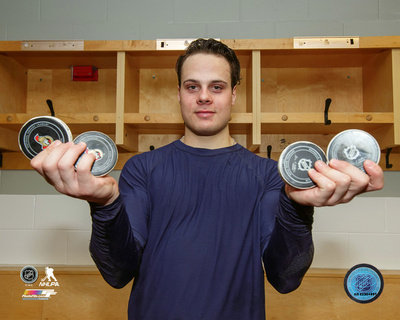 Auston Matthews holding the 4 pucks after he scored four goals in his first NHL Game 10/12/16 Photo