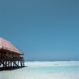Beach Hut Over Shallow Water Photographic Print