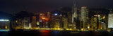 Buildings Lit Up at Night, Hong Kong, China Lámina fotográfica por Panoramic Images Buildings Lit Up at Night, Hong Kong, China Lámina fotográfica por Panoramic Images
