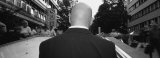 Rear View of a Businessman Standing on an Escalator, Stuttgart, Germany Photographic Print by Panoramic Images 