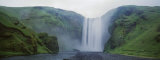 Panoramic View of a Waterfall, Skogafoss Waterfall, Skogar, Iceland Lámina fotográfica por Panoramic Images Panoramic View of a Waterfall, Skogafoss Waterfall, Skogar, Iceland Lámina fotográfica por Panoramic Images