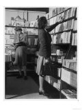 Two Women Both Wearing Box Pleated Skirts Browse Around a Bookshop Giclee Print