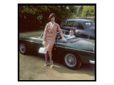 Girl in a Smart Summer Suit Poses Next to Her Boyfriend's MGB Sports Car Lámina giclée